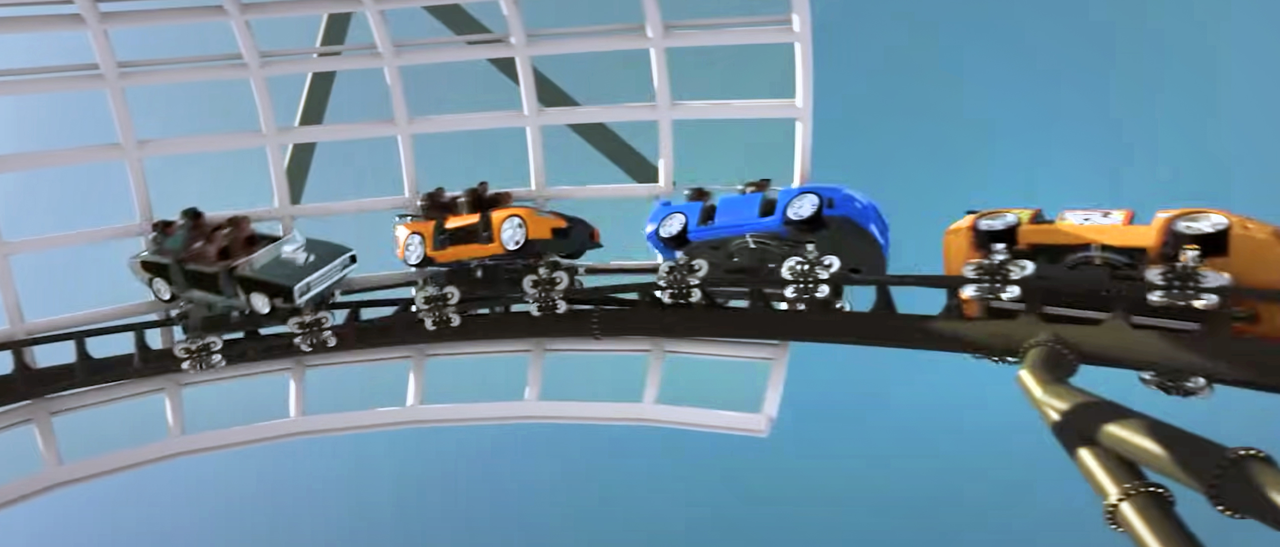 A rendering of a roller coaster with spinning cars on a track.
